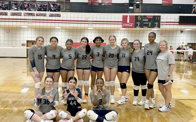 The Lady Devils volleyball team poses after getting their first win over Rabun County in program history Oct. 8. The win came in the first round of the Area 8A tournament and was also Elbert’s first win in the area tournament. (Photo courtesy of Anya Human)