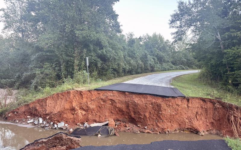 The rate at which water fell Thursday into Friday morning caused several areas of roads to fail including this 35-foot wide washout in the Moore Road/Craft Road area in the Rock Branch community. (Photo submitted by Monica Vickery)
