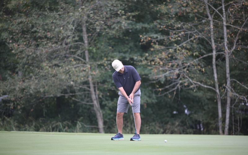Tim Gaines putts towards the hole during the Jimmy Johnson Classic. (Photo by Mark Wells)