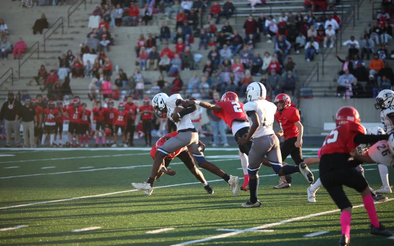 Qua Cureton runs through a pair of defenders during the NEGIAA Championship game. (Photo by Wells)
