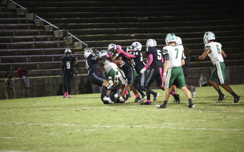 A host of Devils wrap up an Athens Academy ball carrier. (Photo by Wells)