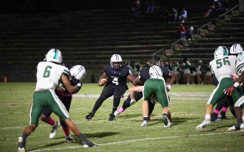 No. 4 Jayvyn Hickman follows lead blocker No. 64 Camron Ardister during Elbert’s loss to Athens Academy Oct. 18. (Photo by Wells)