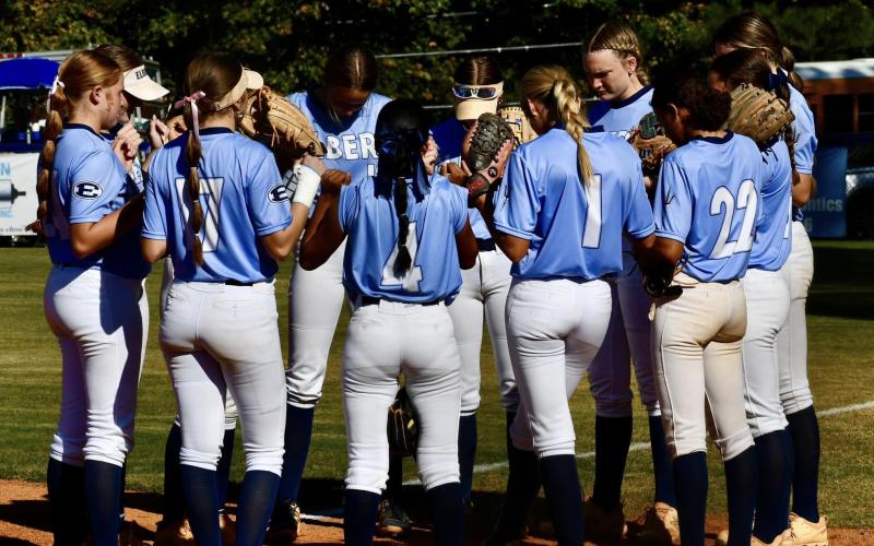 The Lady Devils hold a pregame prayer prior to starting the series against Bremen Oct. 24. (Photo by Bethany Booth - Elbert County True Blue)