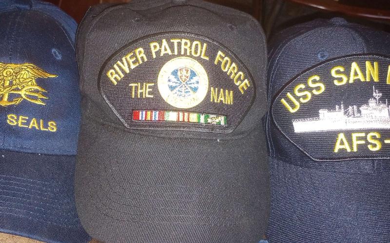 Oglesby still has several hats as momentos from his time in the Navy. (Photo submitted by Wilburt Oglesby)