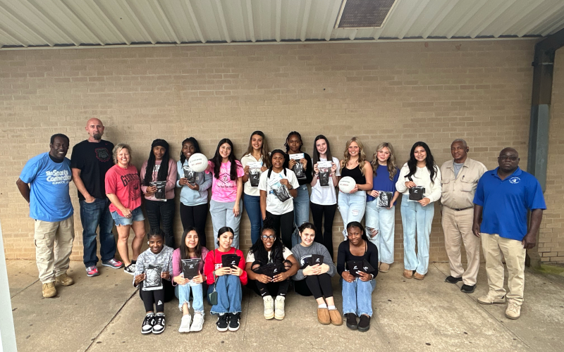 Pictured with some of the donated equipment are (front row, L-R) De’Shayla Jackson, Jessica Flores, Lindsay Castro, Trania Skelton, Amelia Phillips and Aerial Oglesby and (back row, L-R) Freddie Baker, Assistant Coach Shaun Human, Head Coach Anya Human, Anaja Banks, Shamya Davis, Dayana Mota, Melanie Badillo, Lakeria Bradley, Shania Huff, Peyton Roach, Cadence Noggle, Kendall Baston, Zurina Dillard, James Jordan and Alfred Dye. (Photo by Wells)