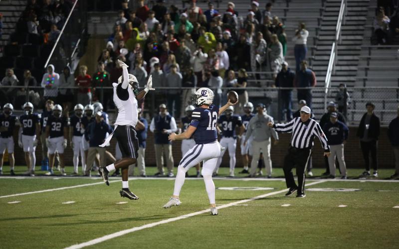 Jermaine Sims leaps and attempts to swat a Gordon Lee pass during Elbert’s 28-13 win over the Trojans Nov. 15. (Photo by Wells)