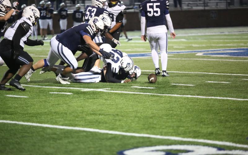 No. 42 Gilbert Fortson sacks the quarterback and knocks the ball loose while No. 3 Jermaine Sims dives over him to make the recovery. (Photo by Wells)