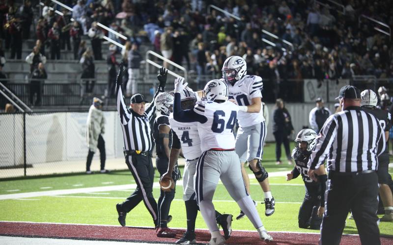 No. 64 Camron Ardister and No. 50 Landon Williams celebrate with No. 4 Jayvyn Hickman after Hickman scored a rushing touchdown in the win over Heard County. (Photo by Wells)