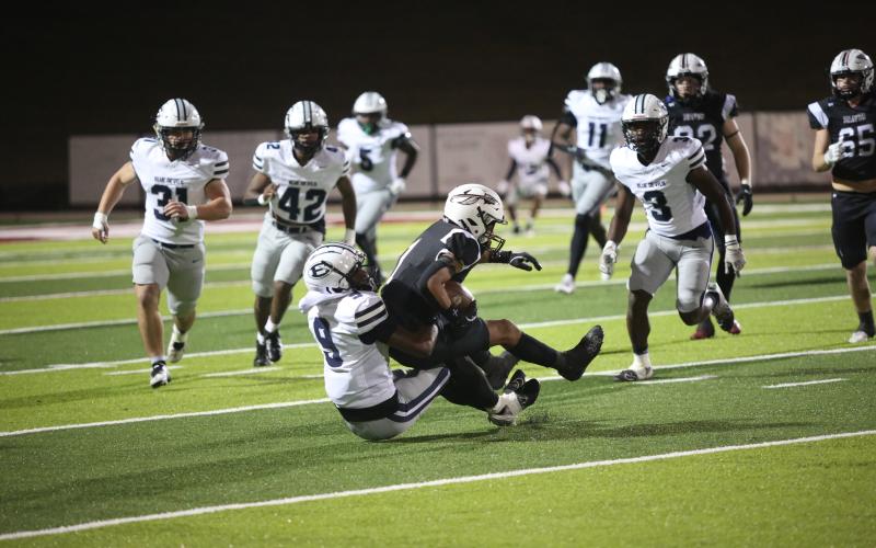 No. 9 Braylen Huff wraps up the Heard County running back during Elbert’s second-round playoff win over the Braves Nov. 22. (Photo by Wells)