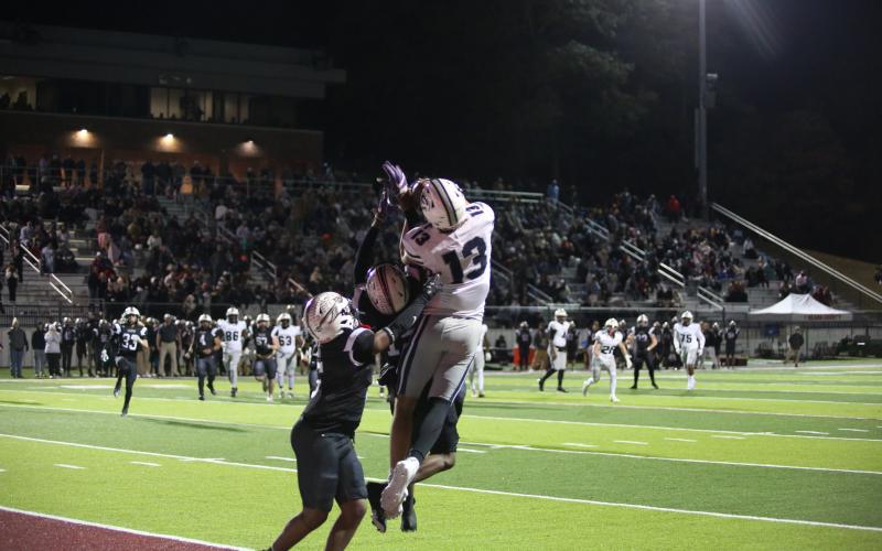 No. 13 Brady Dickerson makes a leaping catch in double coverage to give Elbert the lead late in their second-round playoff game against Heard County Nov. 22. (Photo by Wells)