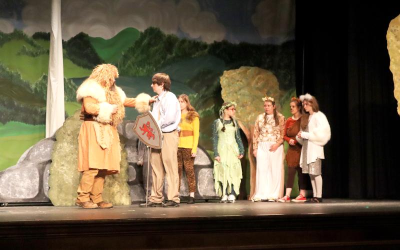 King Aslan (Justin Mitchell) instructs Peter (Triplett) on his mission while in Narnia as other Narnian characters stand by including (L-R) Cheetah (Annabelle Anderson),  Green Dryad (Lina Keblish), Unicorn (Elin Massey), Fox (Isabella Echols) and White Stag (Kinnsley Anderson). (Photo by Weeks)