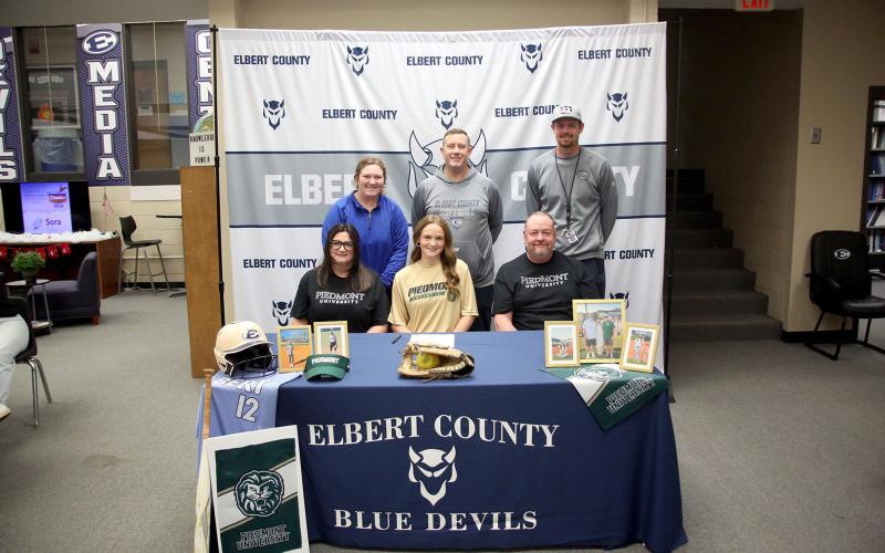 Lady Devil softball player Emily Booth signed her letter of intent to join former Elbert County softball Head Coach Drew Greer and play college softball at Piedmont University Dec. 16. Pictured with Booth during the signing ceremony are (front row, L-R) Bethany Booth, Emily Booth, Greg Booth and (back row, L-R) Faith Burgamy, Josh Jones and Bryce Bowen.