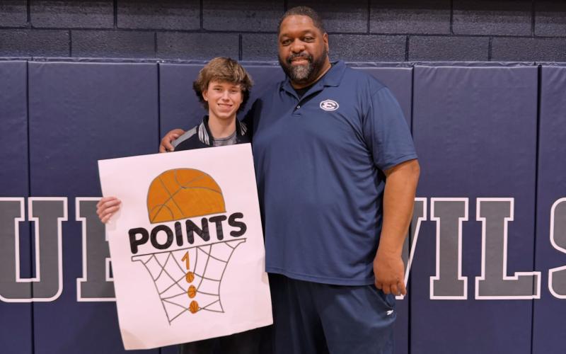 Grady Jones poses with Head Coach Ed Geth after the game where he hit 1,000 career points in an Elbert County uniform. (Photo courtesy of Elbert County True Blue)