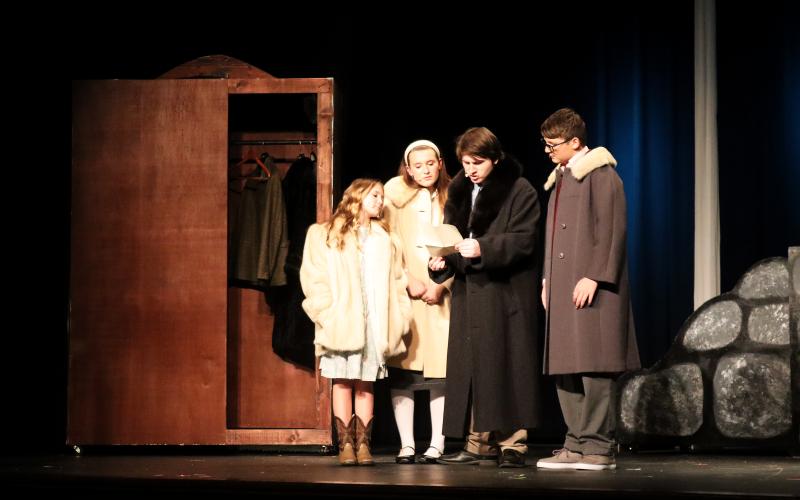 Lucy (Lyla Kate Johnson), Susan (Adrianna Pennington), Peter (Jake Triplett) and Edmund (Parker Jenkins) examine some mysterious instructions after entering Narnia via the wardrobe. (Photo by Weeks)