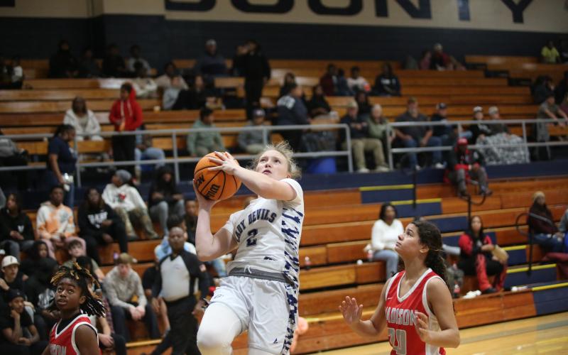 Audrey Lunsford shields the ball from a Madison County defender as she goes up to the basket Dec. 7 (Photo by Wells)