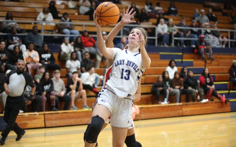 Madison County transfer Sarah Blackmon lays the ball into the basket while drawing a foul off of her former Lady Raider teammate, giving the Lady Devils a crucial three-point play in the dying minutes of Elbert’s win over Madison County. (Photo by Wells)