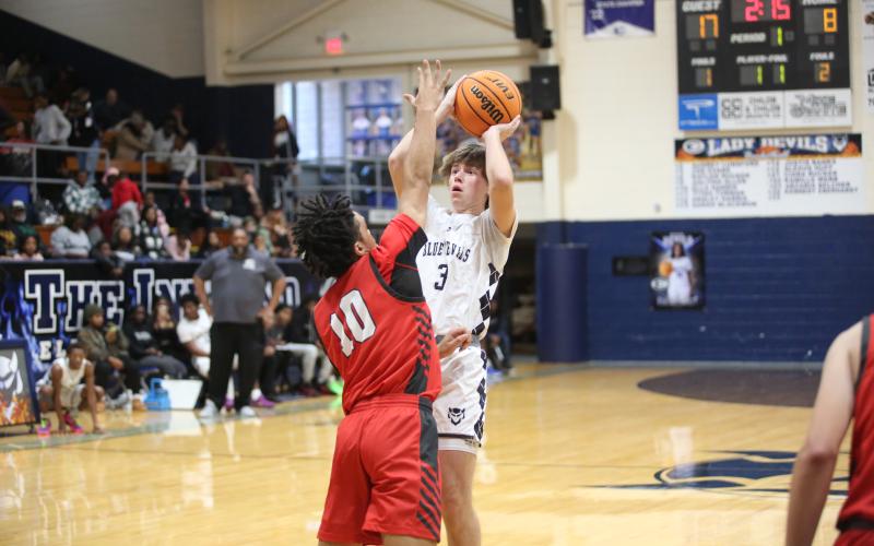 Grady Jones lets a three-point shot fly over a Madison County defender. (Photo by Wells)