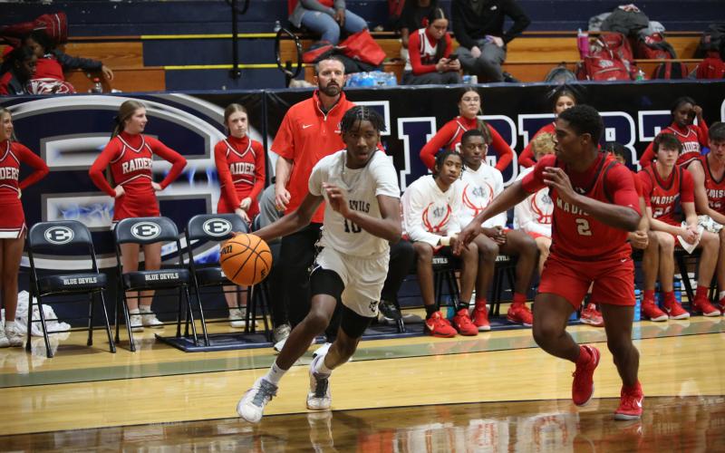 A.J. Brown drives to the basket in front of the Madison County bench Dec. 7. (Photo by Wells)