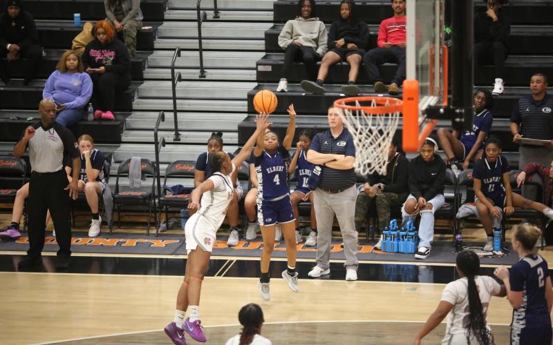 Kaylen Rucker puts up a three pointer while Head Coach Josh Jones looks on. (Photo by Wells)