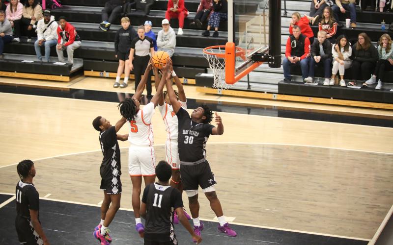 Jase Mattox steals a rebound from two Hart County defenders before putting it back for two points during the McDonald’s Shootout Dec. 28. (Photo by Wells)