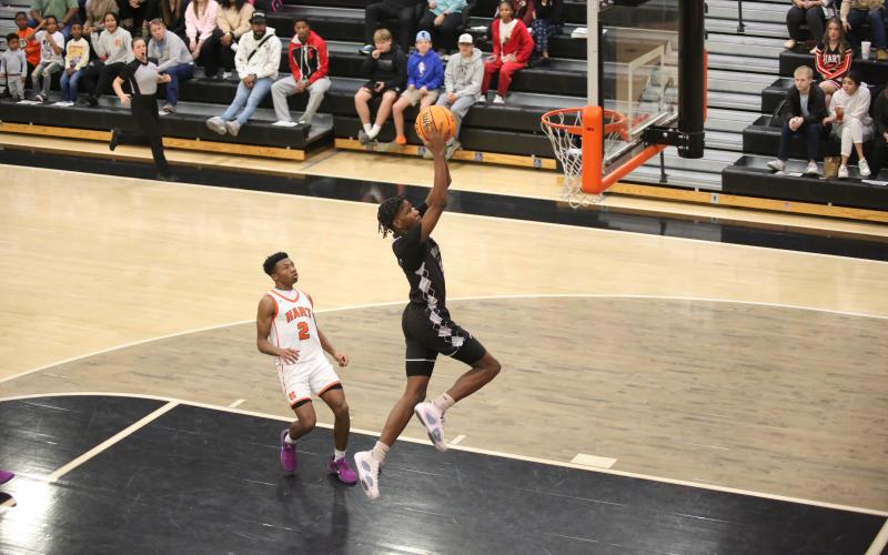 A.J. Brown soars through the air to punctuate a fast-break chance with a slam dunk during Elbert’s loss to Hart County Dec. 28. (Photo by Wells)