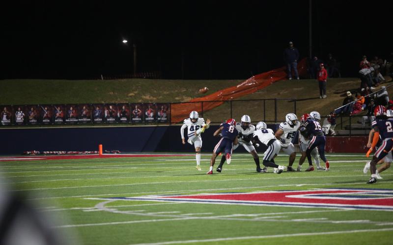 Aczib Bernal punts the ball away during the loss to Toombs. (Photo by Wells)
