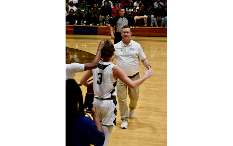Lady Devils Head Coach Josh Jones goes in for a congratulatory hug after his son Grady Jones eclipsed 1,000 career points in Elbert’s game against Hart County Dec. 14. (Photo courtesy of Elbert County True Blue)
