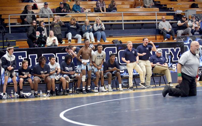 Assistant Coaches Eli Holton and Brice Noggle jump up and yell with excitement after a pin in the Area Duals. (Photo by Wells)