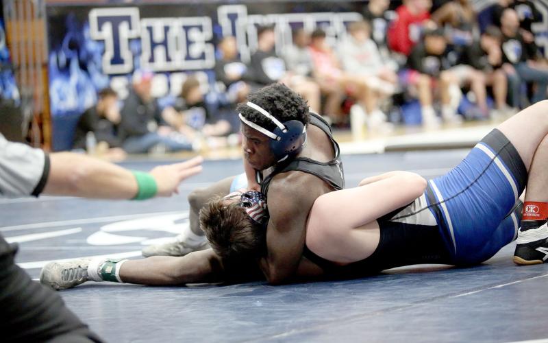 Kingston McIntosh pushes his opponents’ shoulders to the mat as he works on a pin during Elbert’s 81-0 thrashing of Fannin County in the first round of the Area 8A Championship Duals. (Photo by Wells)