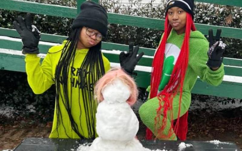 Two unidentified young ladies and their snow creation. (Photo submitted by Crashout Yxnnaa)
