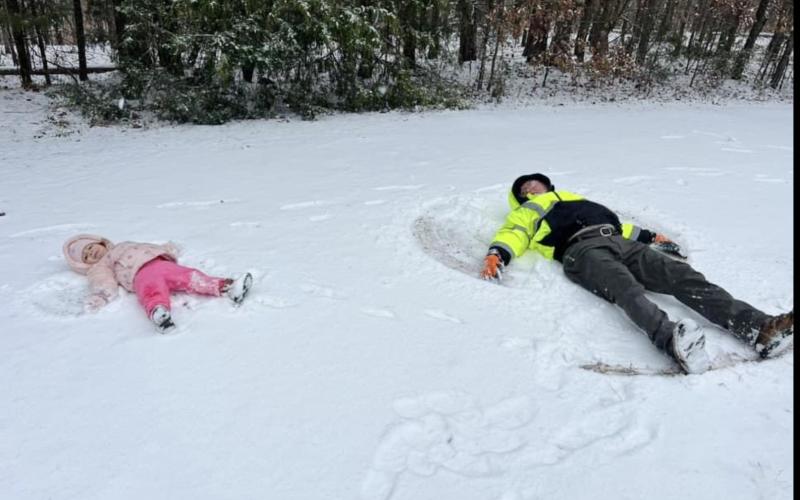 Zariah and her G-Pa making snow angels. (Photo submitted by Riena Donald)