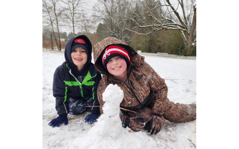 Tucker and Rhett Clark with their snow cat. (Photo submitted by Joy Clark)