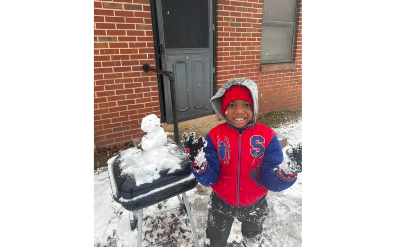 Khiyin McCluney poses with his mini-snowman. (Photo submitted by Kristin McCluney)