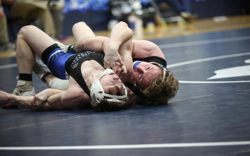 Sawyer West tries to pin a Fannin County wrestler's shoulders to the mat in the first round of the area dual championships Jan. 9. (Photo by Wells)