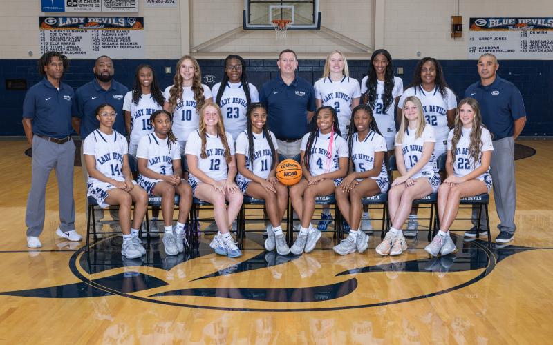 The 2024-2025 Lady Devils varsity basketball team includes Audrey Lunsford, Zoe Evans, Kaylen Rucker, Aaliyah Allen, Ella Harris, Tiyah Turman, Ansley Harris, Sarah Blackmon, Justis Banks, Alexus Huff, Ciara Rucker, Kamille Webb, Zy Belcher and Kennedy Eberhardt. The team is coached by Head Coach Josh Jones and Assistant Coaches Donald Bolton, James Allen and Sonee Bennett. (Photo by Mercer Harris)