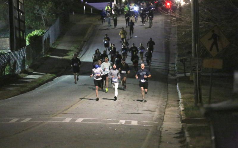 Over 100 participants of the 21st annual Twilight Stroll hosted by the Elbert County Chamber of Commerce travel the first leg of the 3.1 mile race in downtown Elberton on Friday, Jan. 3. (Photo by Wells)