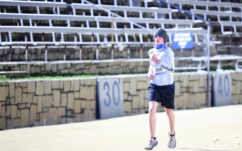 Elbert County Blue Devil cross country athlete Tommy Beahringer runs through the Granite Bowl during the Twilight Stroll. (Photo by Wells)