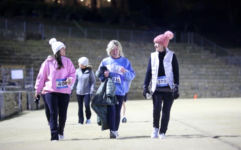 (L-R) Kaitlin Walker, Christy Hart and Ruth Westbrook stroll through the Granite Bowl as they near the finish line of the Twilight Stroll by the Granite Bowl Jan. 3. (Photo by Wells)