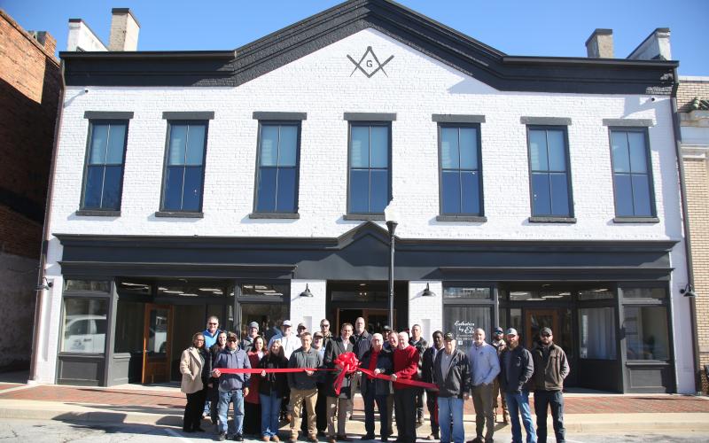 City council members, Main Street representatives, representatives from the office of John Ossof and local citizens cut the ribbon at the remodeled Bailey Building which will be home to two retail shops and two apartments upstairs.