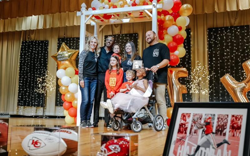 During the Feb. 22 pageant, FHF awarded the Family of the Year award to the Moon family. Pictured are (L-R)FHF president Sandy Adams,  Mecole Hardman, Olivia Moon, Avery Moon (held by Abby Moon), Andrew Moon, Miss Little FHF Priya Moon, and Brent Moon.