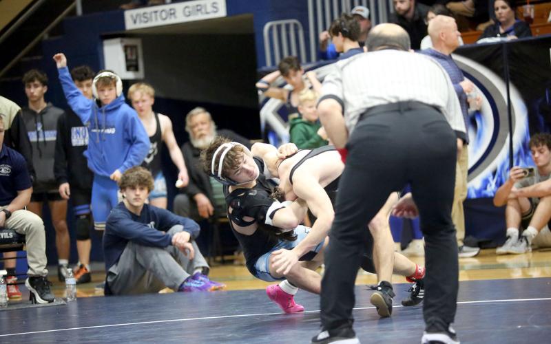 Cruz Floyd pulls his opponent to the mat with the help of a headlock during the area traditional championships. (Photo by Wells)