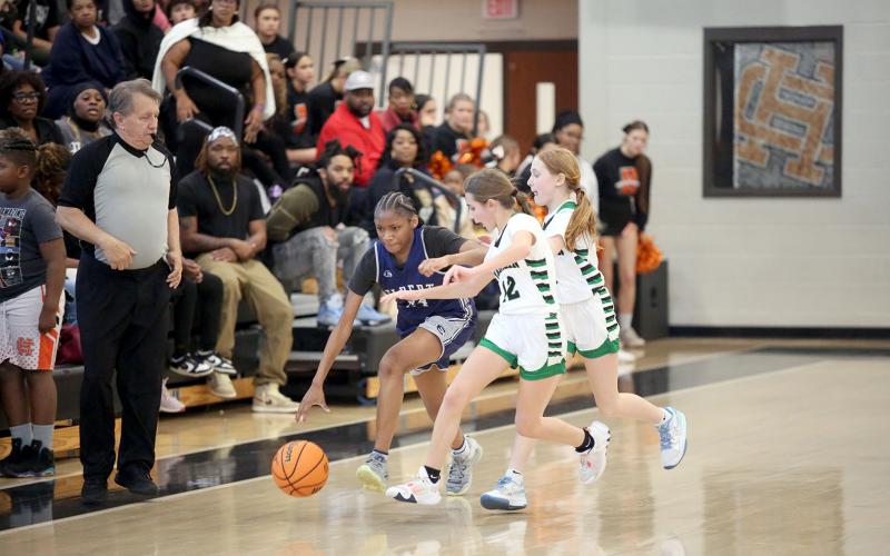 Lisa Hill dribbles past a Franklin County double team during the NEGIAA seventh-grade region championships hosted by Hart County Feb. 1. Hill led the Lady Rams in scoring with 16 points. (Photo by Wells)