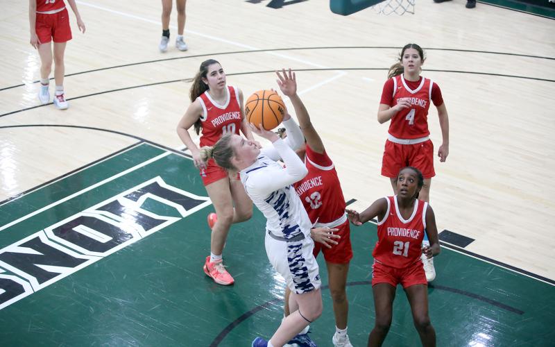 Audrey Lunsford goes up to the basket with a hand in her face Feb. 14. (Photo by Wells)
