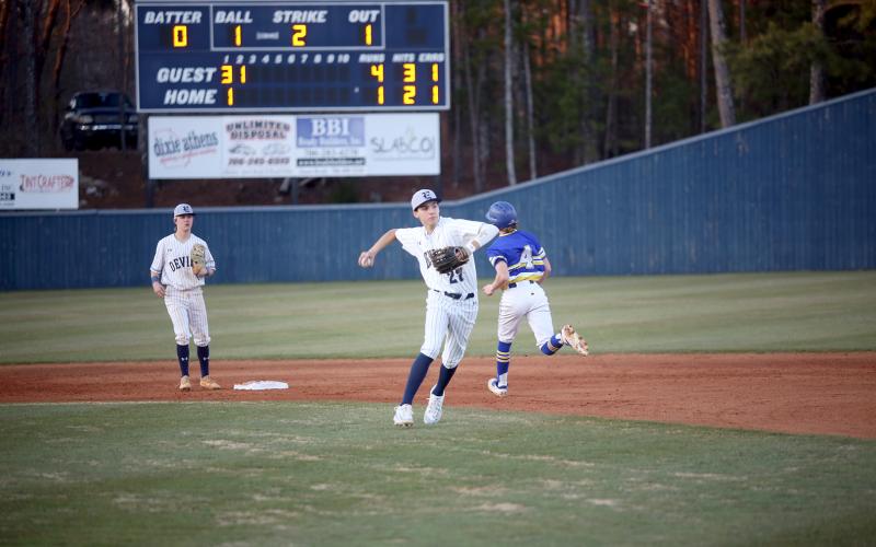 Rylan Brown fields the ball from second base and throws over to first to beat the runner. (Photo by Wells)