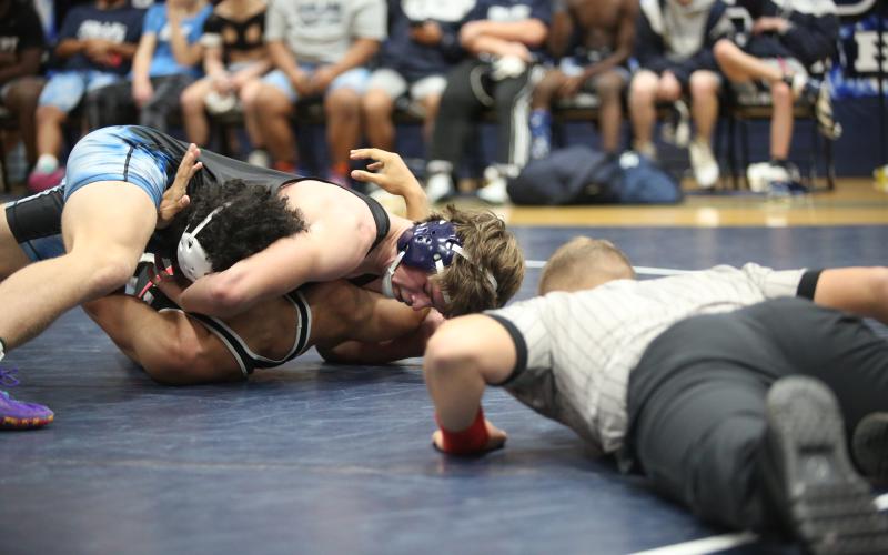 Brycin Hughes looks at his opponent’s shoulders as he rolls them onto the mat to finish off a pin. Hughes is one of seven Elbert wrestlers who qualified for the upcoming GHSA Traditional State Championship meet. (File photo by Wells)