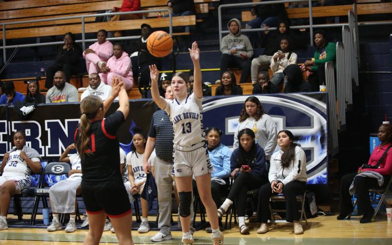 Sarah Blackmon puts up a three-pointer while the Lady Devil bench looks on. (File photo by Wells)