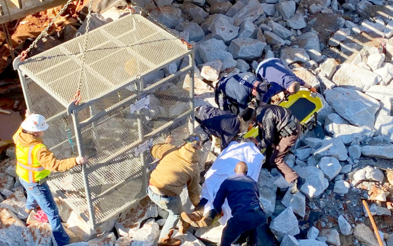 EMS team members move the injured worker onto the gurney prior to loading him into the quarry box to be lifted to safety. (Photo courtesy of Elbert County Emergency Services)
