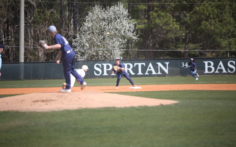 Brayden Ingram waits for the ball thrown by pitcher Colson Brown as the Devils try to catch an Athens Academy runner off of his base. (Photo by Wells)