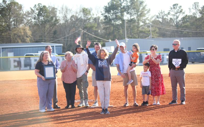 Kim Harper Bray (center) waves to the crowd during her jersey-retirement ceremony in between the Lady Devils softball team's doubleheader against Johnson March 12. (Photo by Wells)