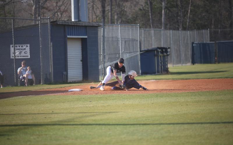 Sam Amabile absorbs contact from a sliding runner, but still gets the out during the win over Barrow Arts and Sciences Academy. (Photo by Wells)